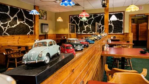 Colourful model cars displayed along the restaurant counter beneath vintage lamps
