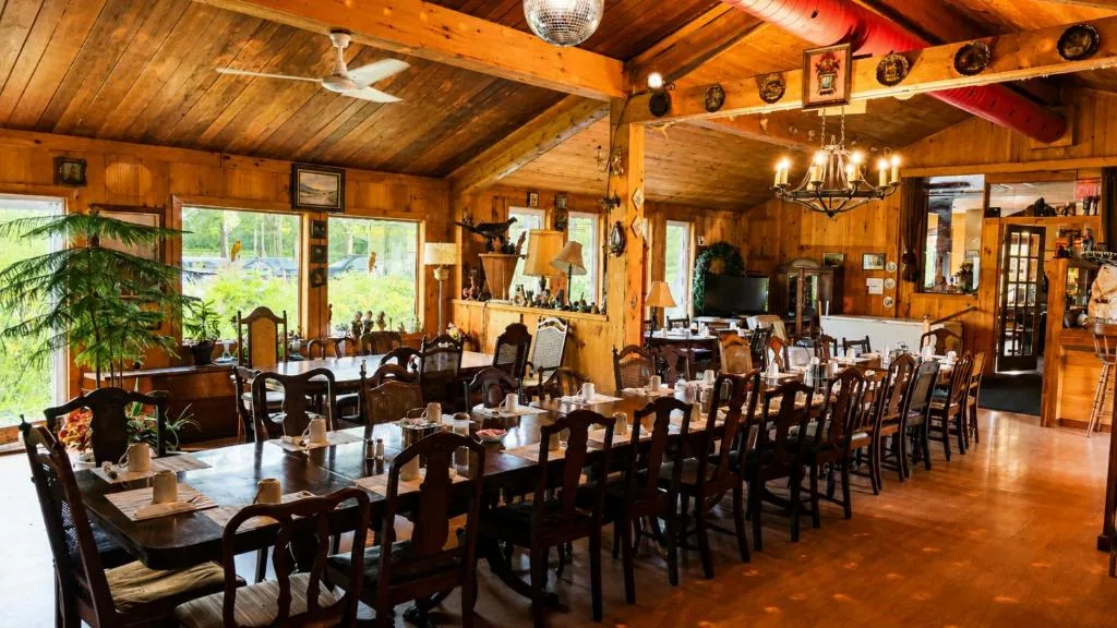 Warm wood restaurant dining room with long tables and vintage decor